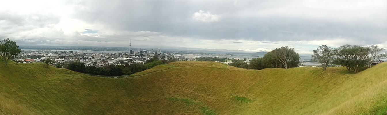 A panoramic view of the Mount Eden Crater with Auckland in the distance