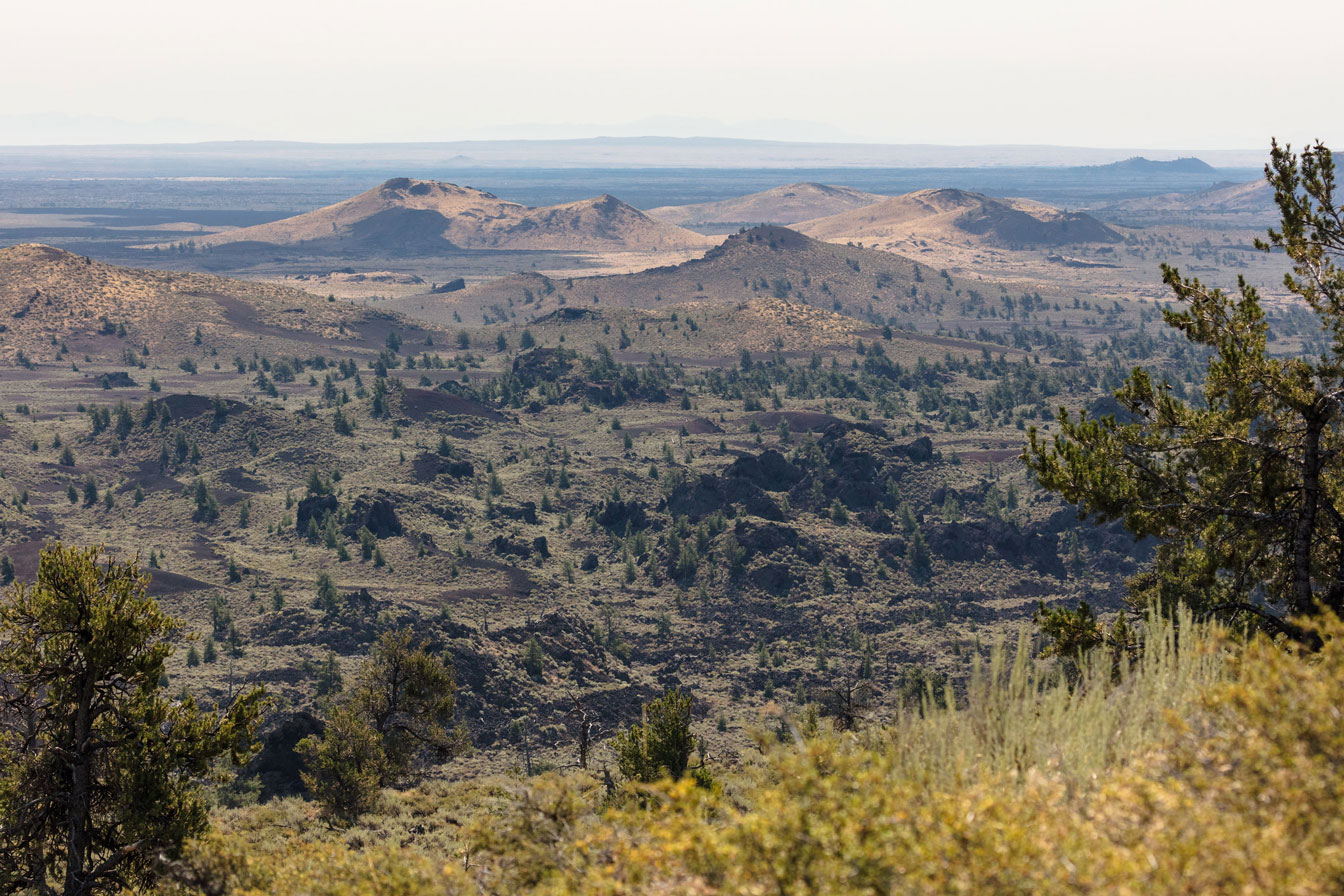 Landscape photo showing the volcanoes of Craters of the Moon National Monument in the distance