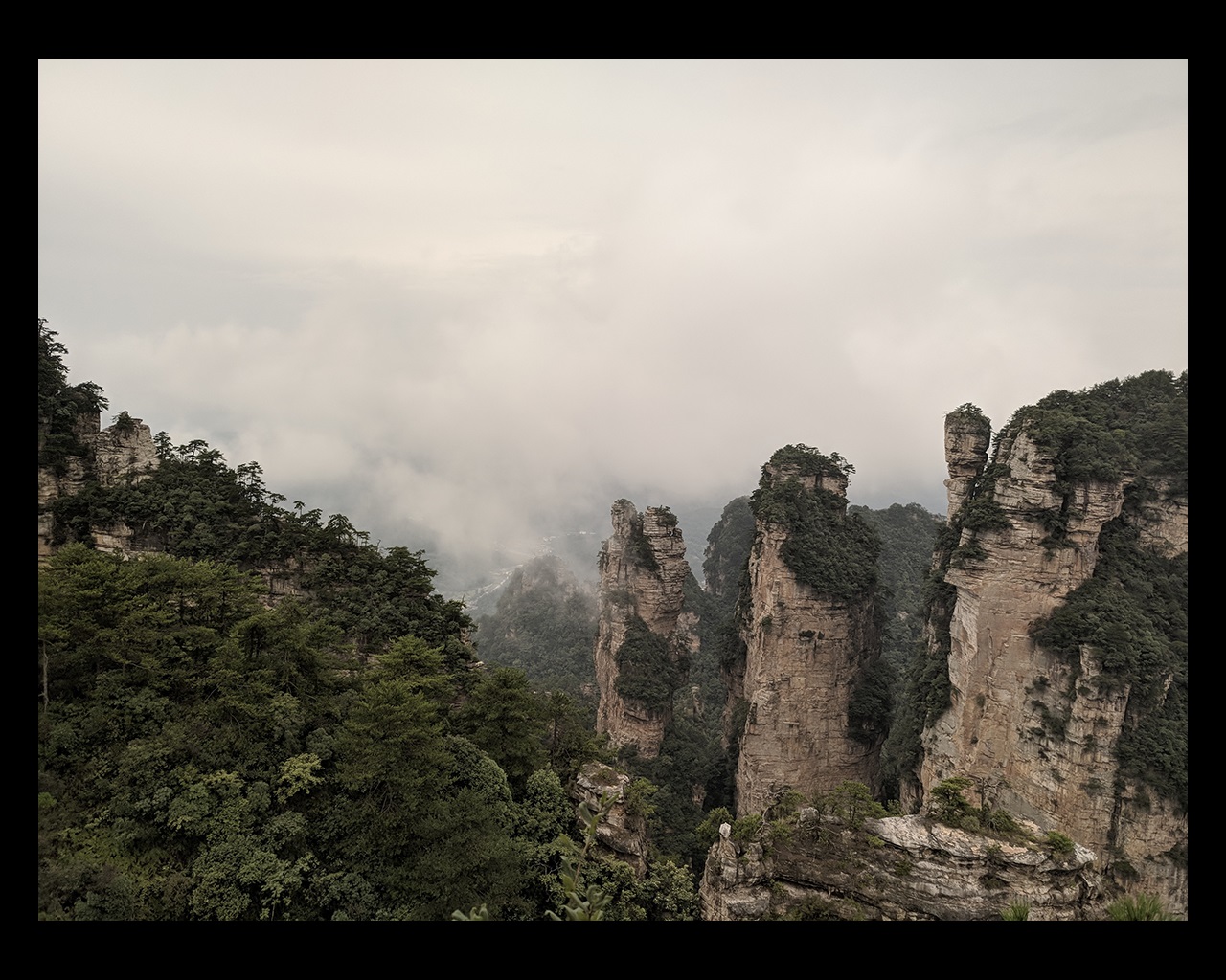 Green mountains surrounded by clouds