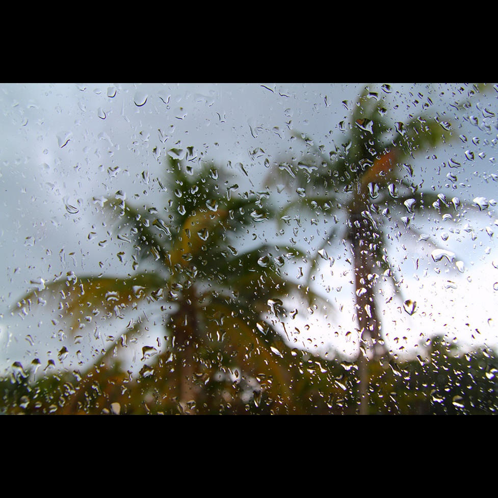 looking out car window during storm with raindrops on glass