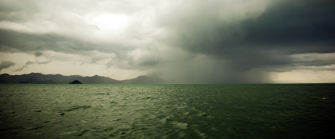 Huge storm clouds with rain over a rough ocean
