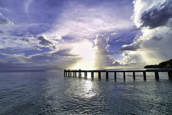 View of an ocean pier and sky at sunrise in Puerto Rico