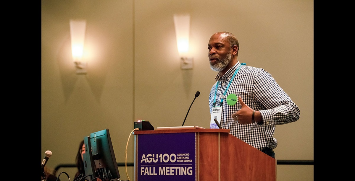 Man speaks at a podium