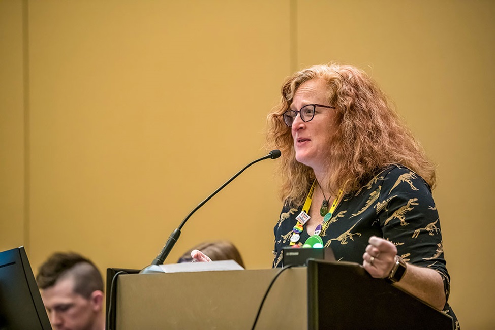 A woman presents at an oral session