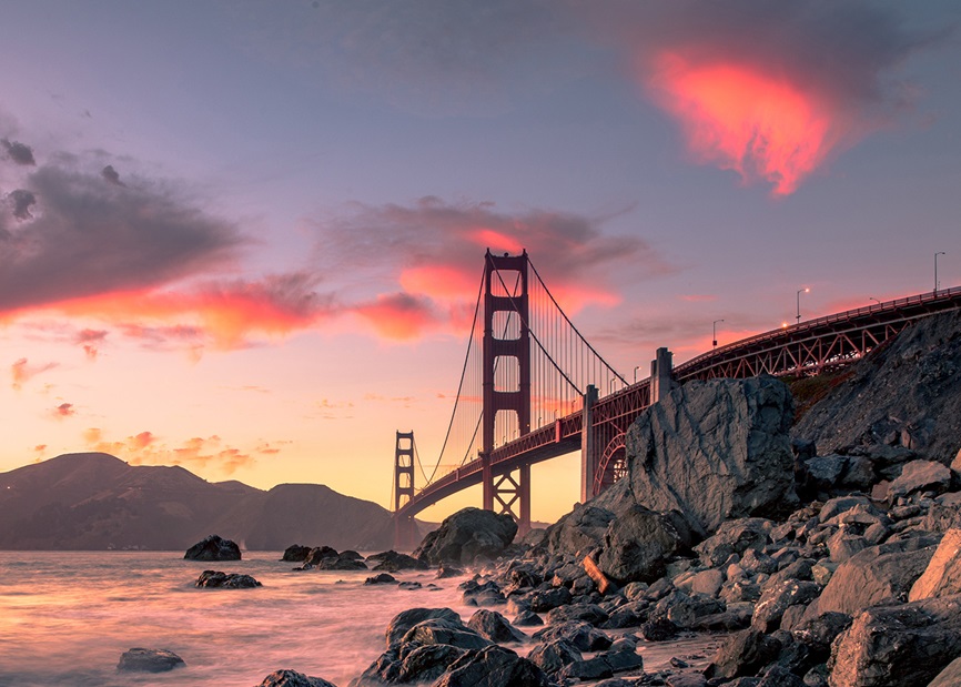 View of Golden Gate bridge from rocky shoreline