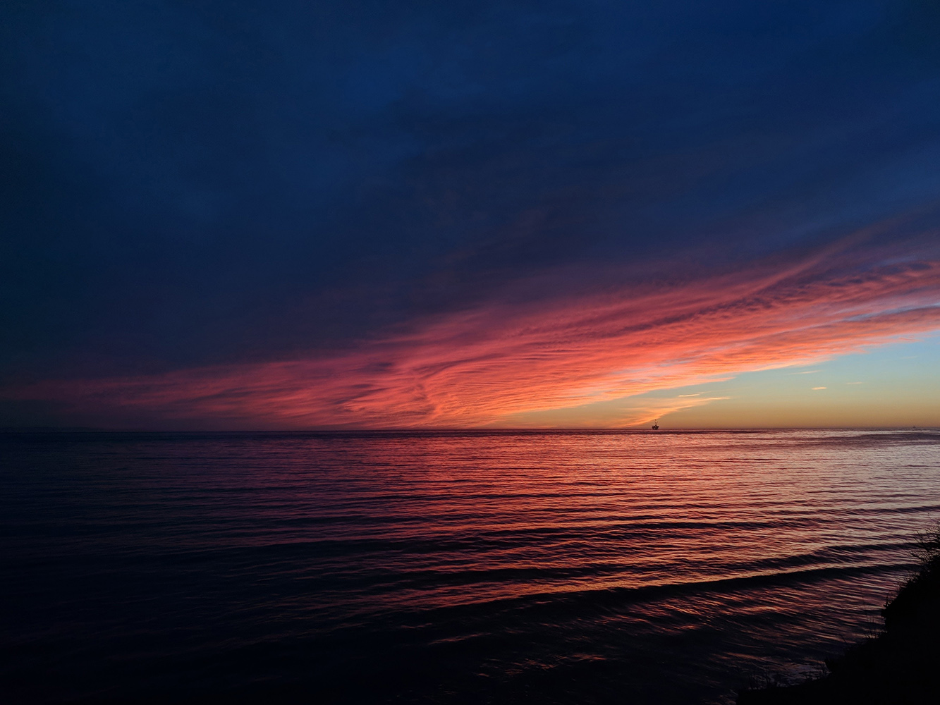 Ocean view at sunset with dark clouds