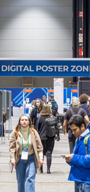 People walking through the poster hall at Fall Meeting 2021 in Chicago, near sign "Digital Poster Zone"