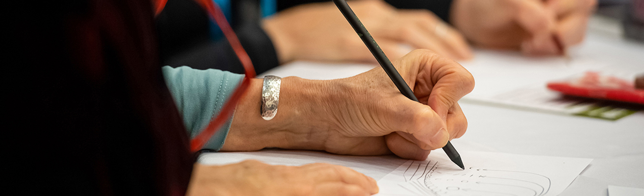 Woman writing at AGU Fall meeting