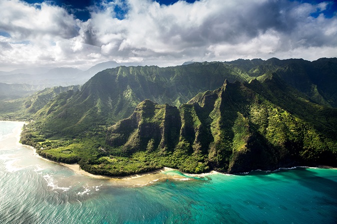 Green mountains on sandy beach, USA