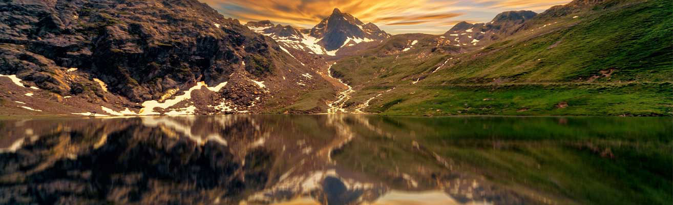 Sunset over lake with mountain reflection