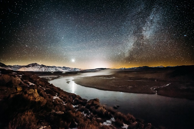 Night view of river and mountains with starry night sky