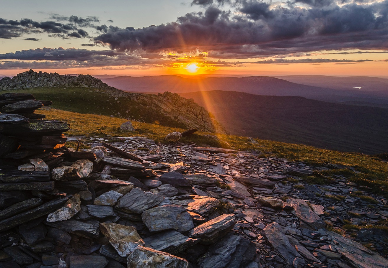  Sunrise over a bed of rocks on side of mountain in Russia