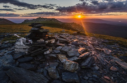 Sunrise over a bed of rocks on side of mountain in Russia