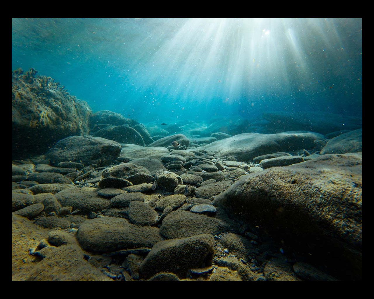 Underwater view of rocks with sunlight, Greece