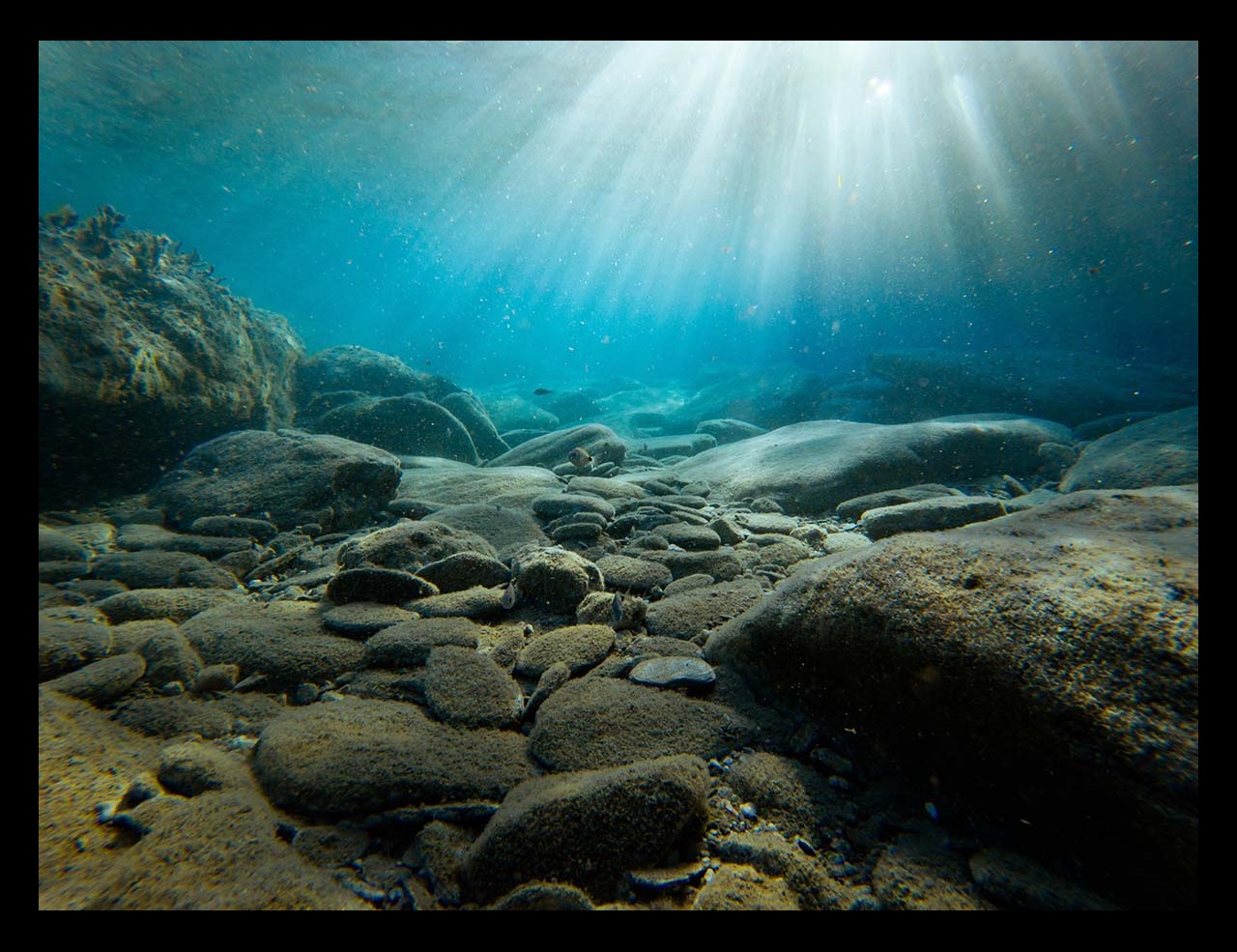 Underwater view of rocks with sunlight, Greece