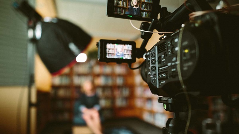 Person sitting in front of video camera for interview