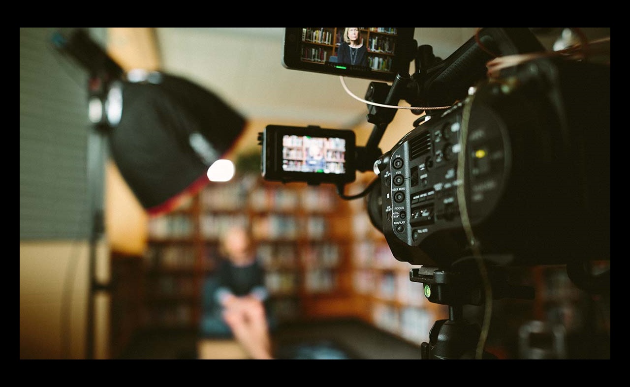 Person sitting in front of video camera for interview