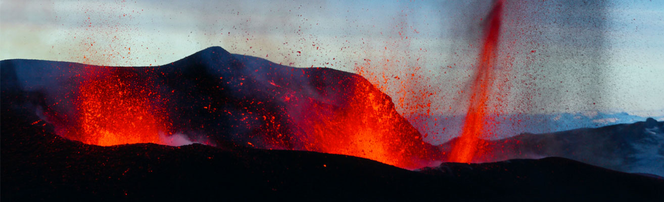 Volcano erupting at dusk