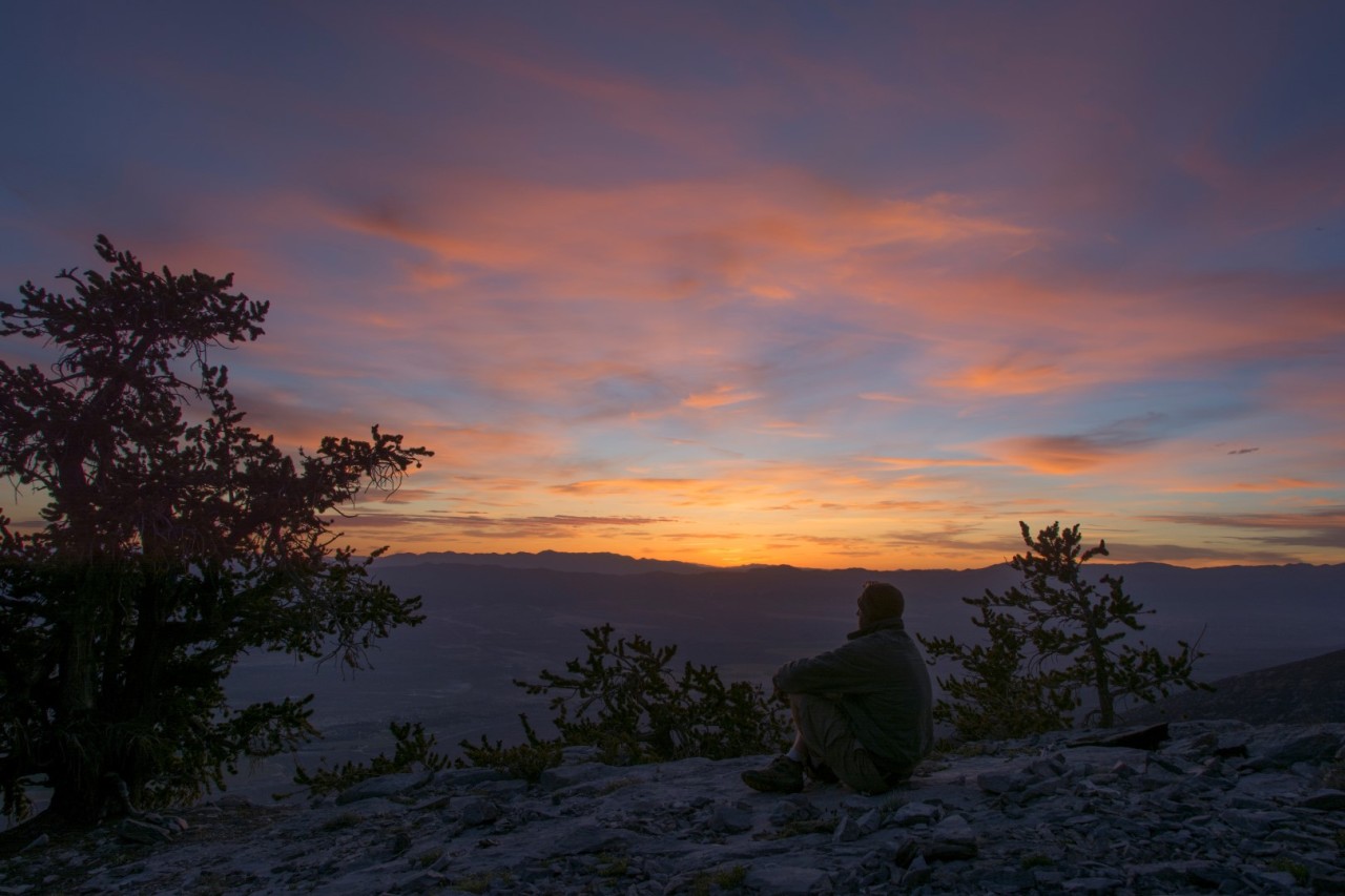 man watching sunset on Mount Washington in Nevada, USA. 
