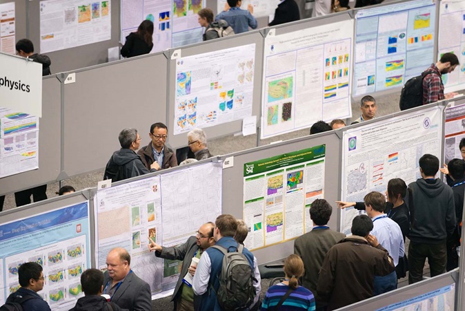 several poster presenters in poster hall
