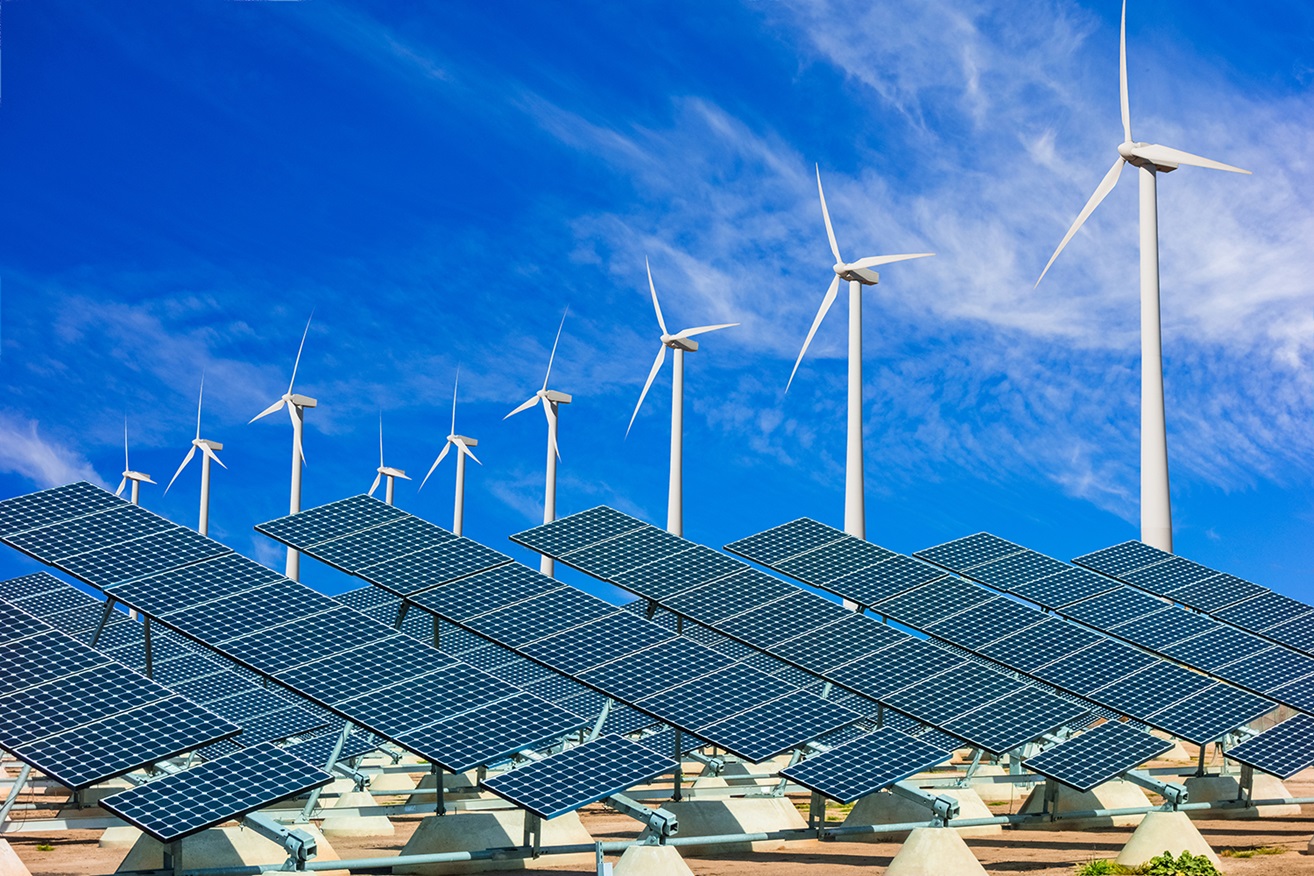 Alternative energy with solar battery panels and wind turbines against blue sky