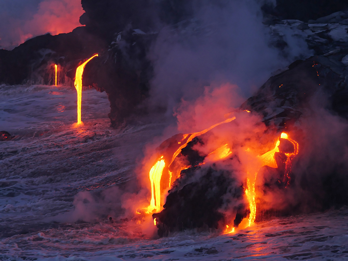 Multiple lava flows falling into the ocean in Hawaii