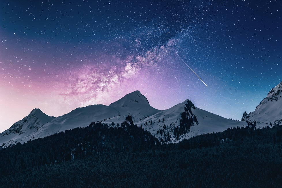 Stars at night over snowy mountains