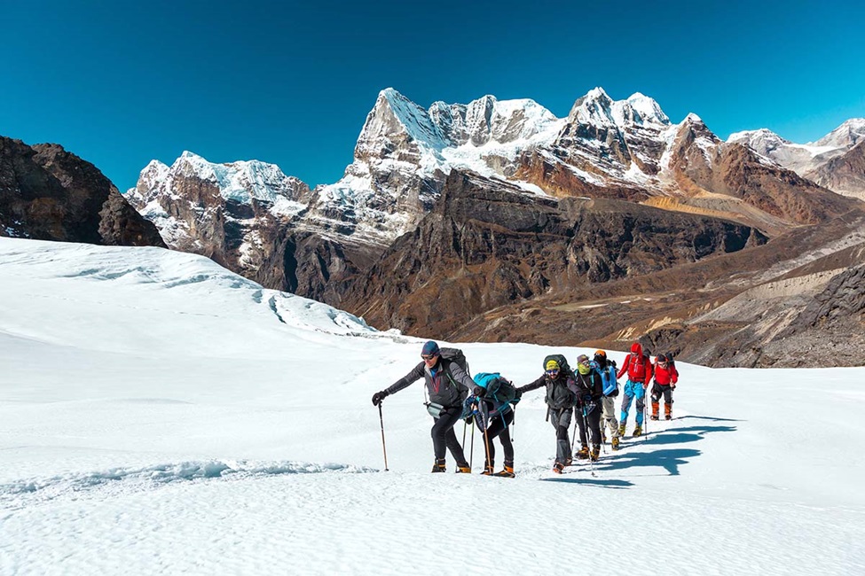 Group of People hiking up a snow covered mountain