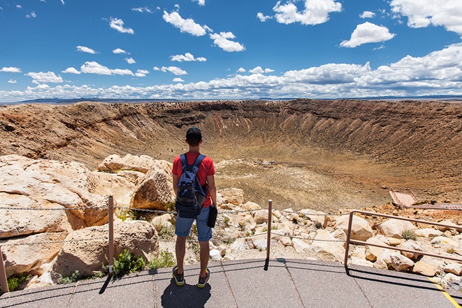 Man hiking in front of a crater