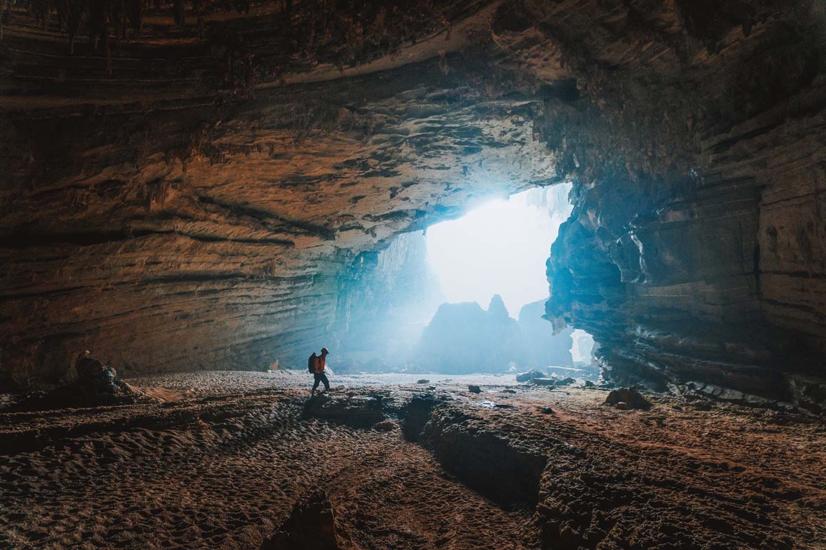 Person in cave with sunlight behind