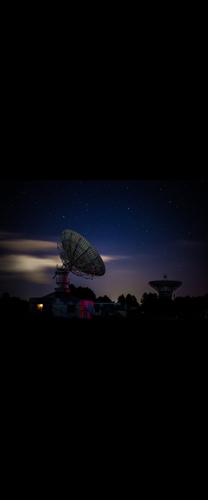 satellite dish under a starry sky