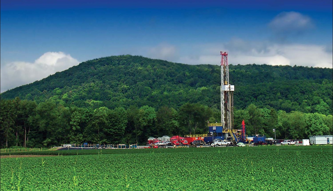 Shale drilling in front of green hill