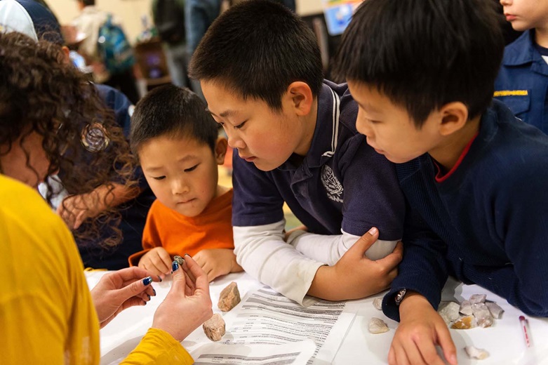 Adult teaching kids about the rocks