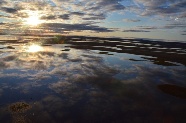 looking out over marshy artic landscape from helicopter