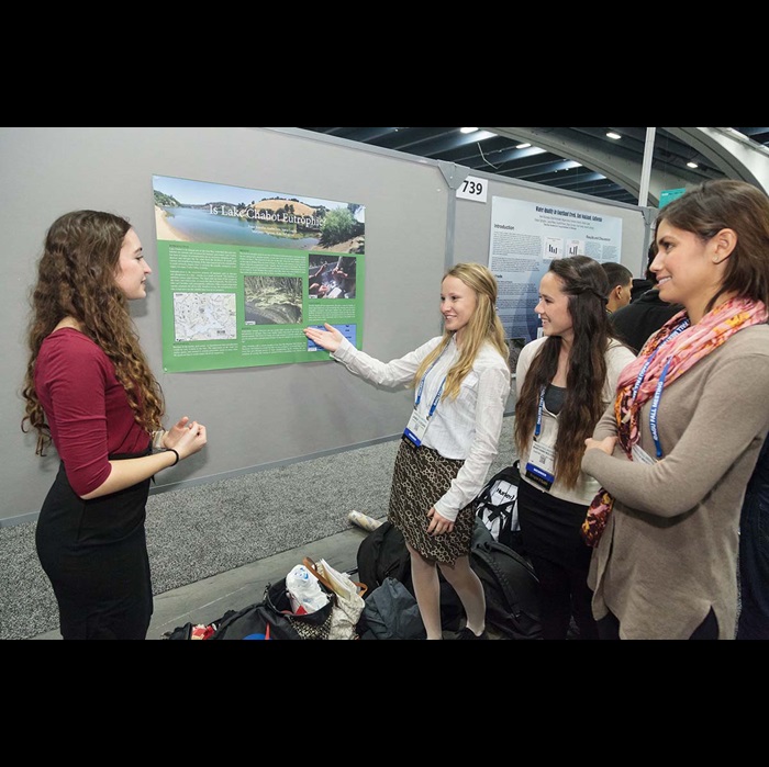 Female students discussing a poster