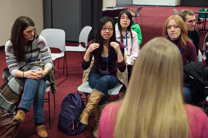 Student speaking to teacher and class