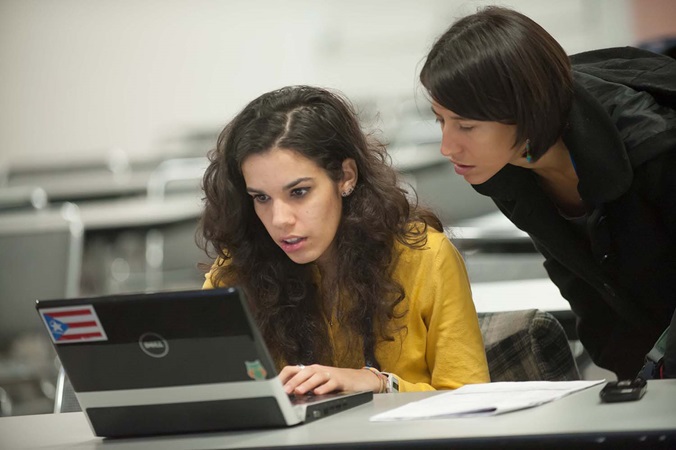 Teacher helping student on computer Teacher helping student on computer