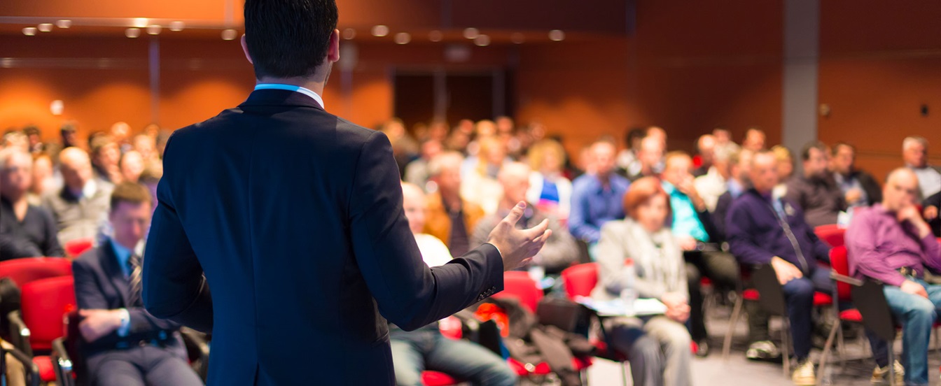 man presenting  in front of audience