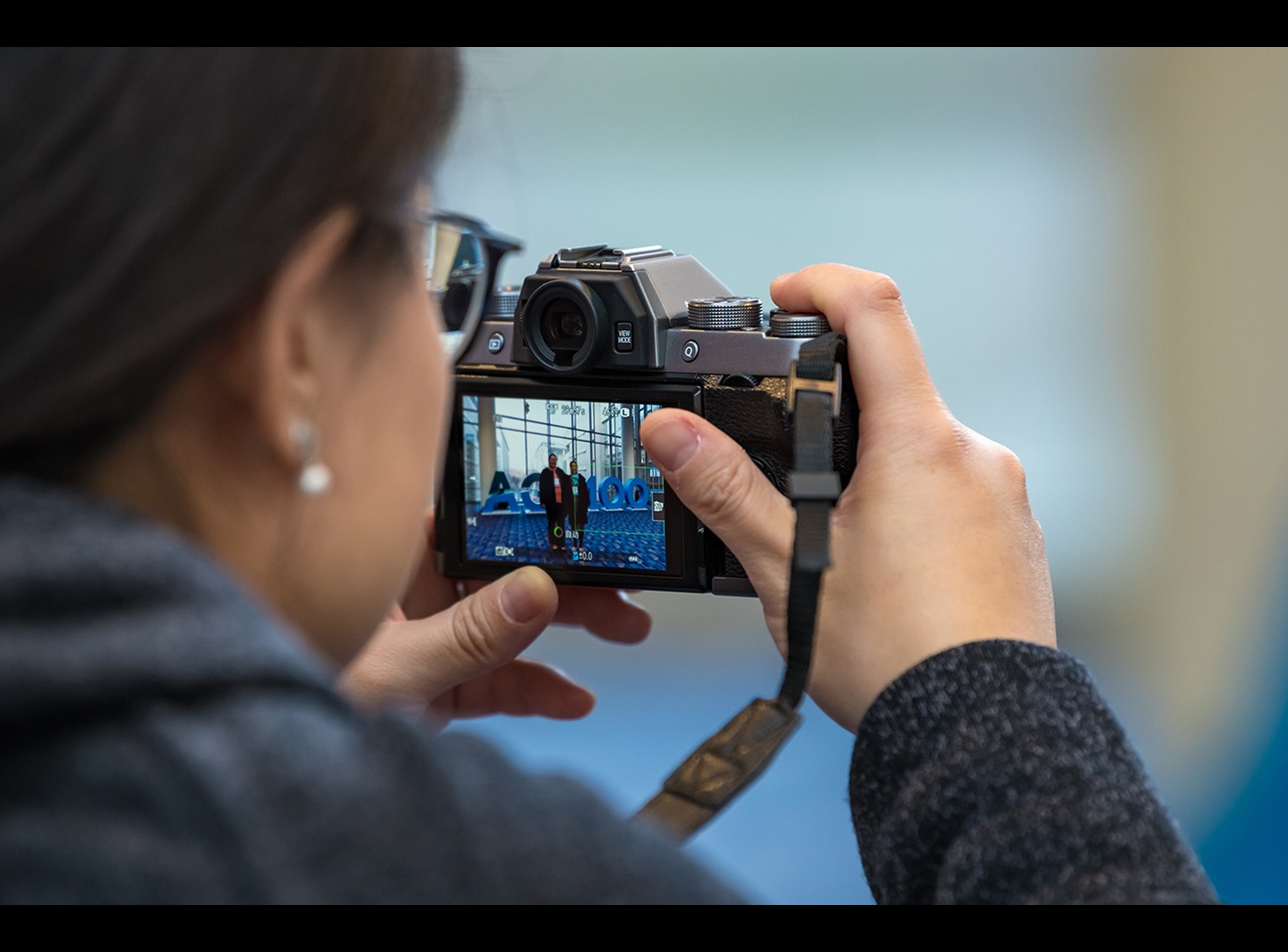 Close up of a woman pointing a camera