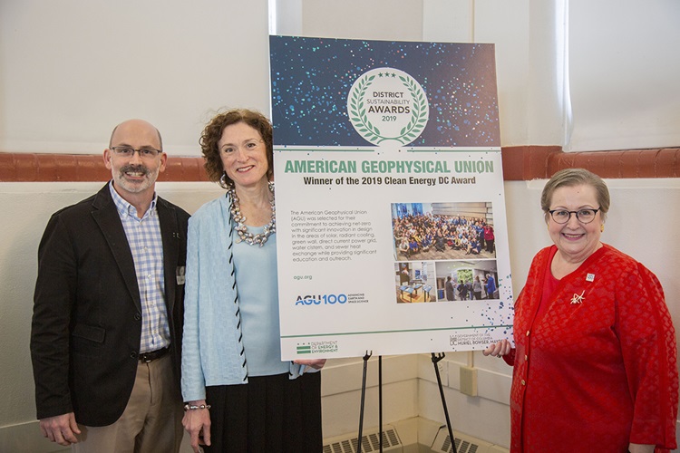 AGU leaders stand by a sign for the DC Sustainability awards AGU leaders stand by a sign for the DC Sustainability awards