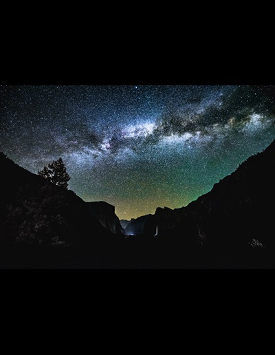 Mountains silhouetted against a starry night sky