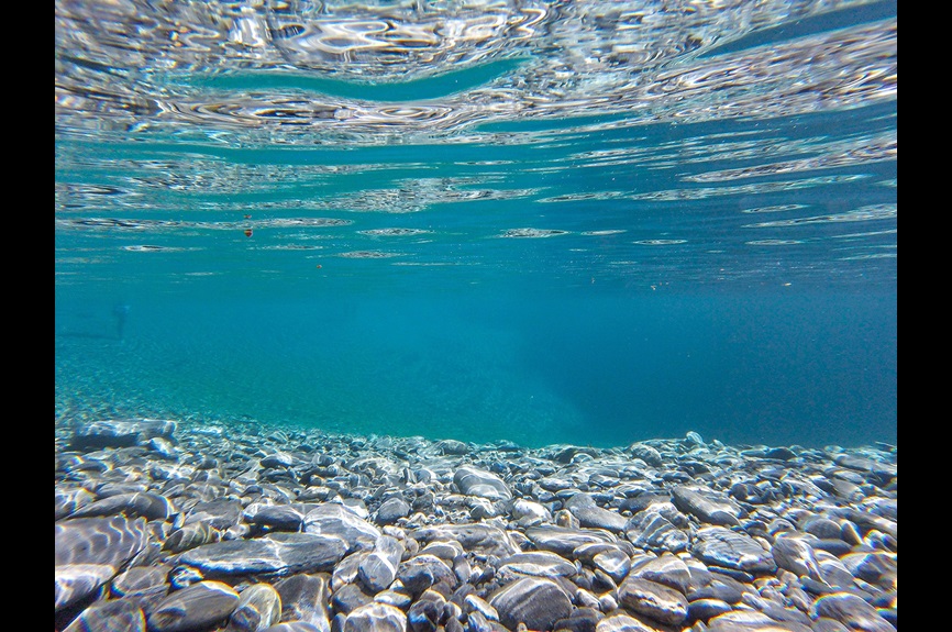 Under blue ocean with floor rocks