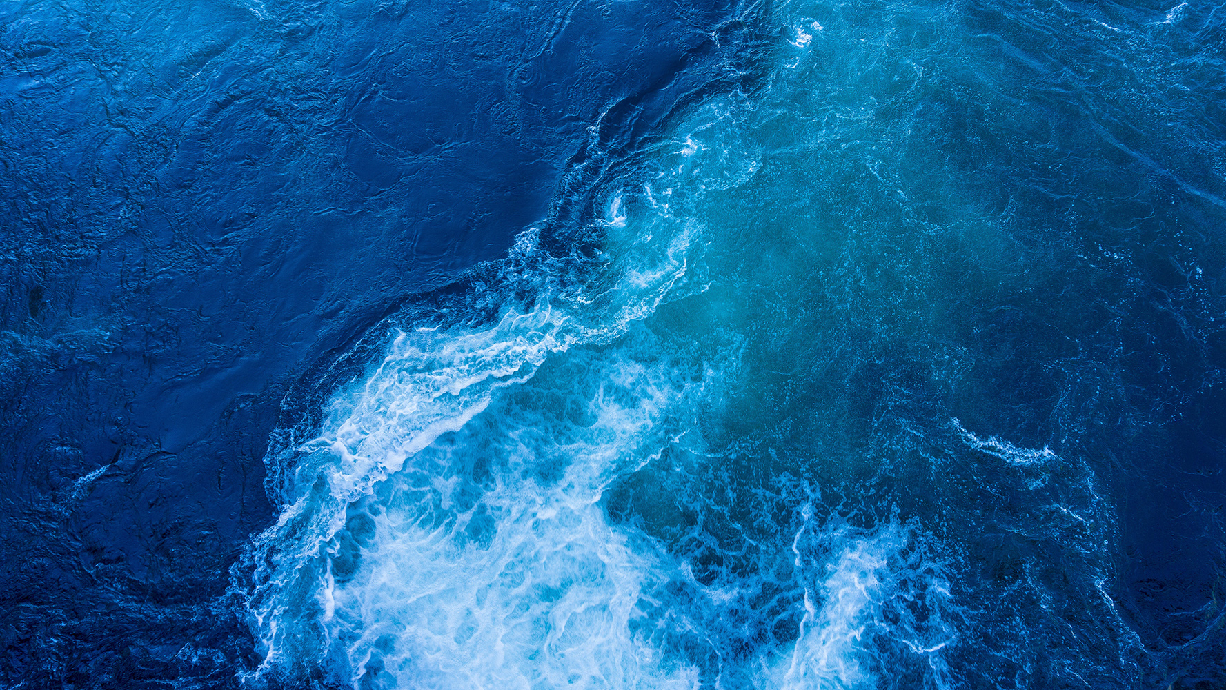 Blue ocean tide with foam