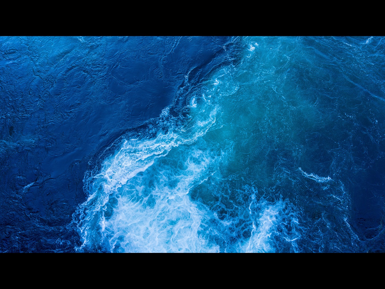 Blue ocean tide with foam