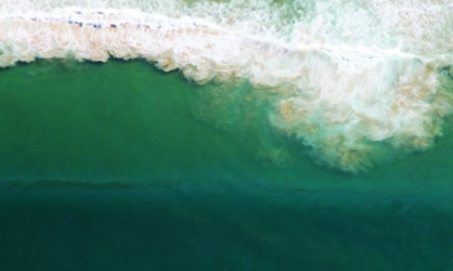 Waves washing up against a coastline.