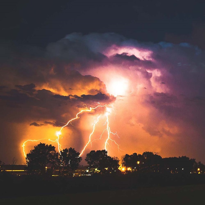 Clouds with multiple strikes of lightning over city