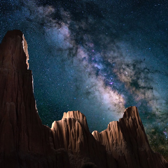 Rock formation shining under a galaxy of stars