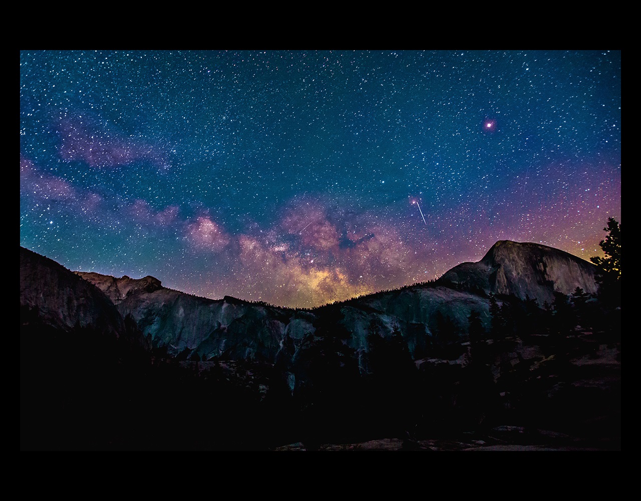 Mountains at night with stars and galaxy