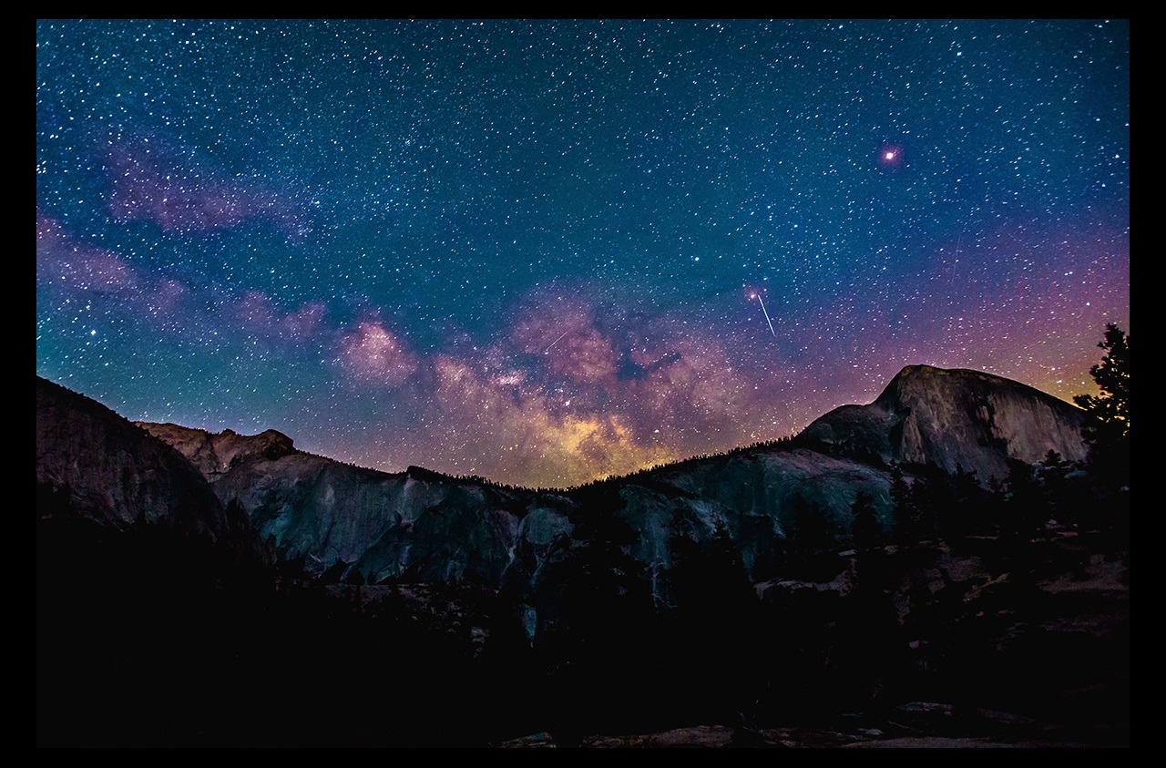 Mountains at night with stars and galaxy