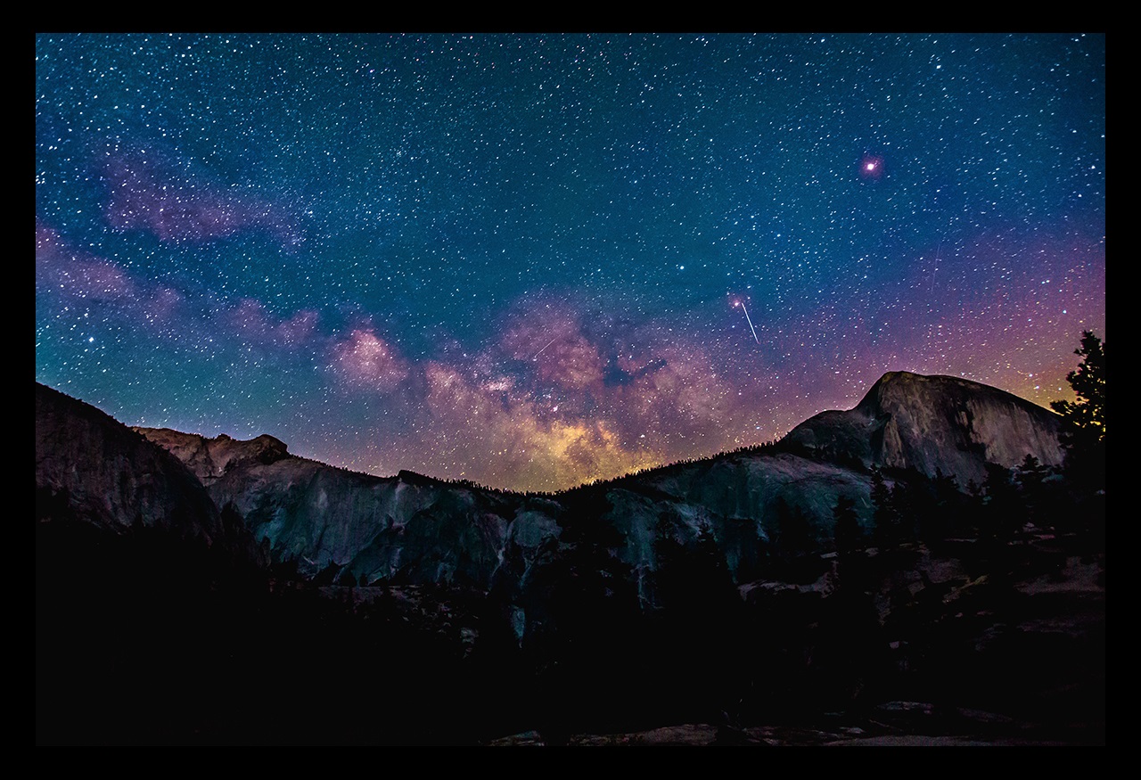 Mountains at night with stars and galaxy